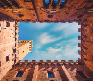 Wide angle view of famous Torre del Mangia at Palazzo Pubblico in Siena, Italy