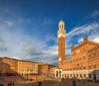 The Piazza del Campo with The Torre del Mangia tower in Siena town in the Tuscany region of Italy, Europe.